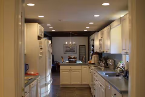 Bright kitchen with white cabinets, appliances, and a central island.