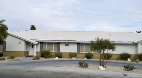 Single-story Silver Horizon Group Home exterior with shrubs and a small tree.