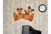 Wall decoration featuring wooden figures of Mickey Mouse and Minnie Mouse holding a sign that says 'Ivy Hall' mounted on a patterned wallpapered wall. A round wall clock showing the time as 12:10 is visible to the right. The top of a black television set is visible at the bottom of the image.