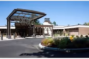 Front entrance to Kline Galland Home with a covered driveway and landscaped area.