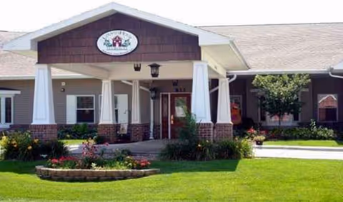 Front entrance of CountryHouse Grand Island senior living facility with landscaped lawn and walkway.