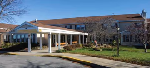 Brookdale Clinton senior living facility exterior with a covered entrance and landscaping.
