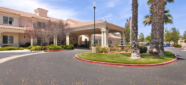 Exterior view of Brookdale Murrieta with landscaped entrance and palm trees.