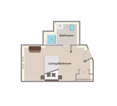 Floor plan of a senior living unit showing a combined living and bedroom area with a bed and dresser, and a separate bathroom with a sink, toilet, and shower.