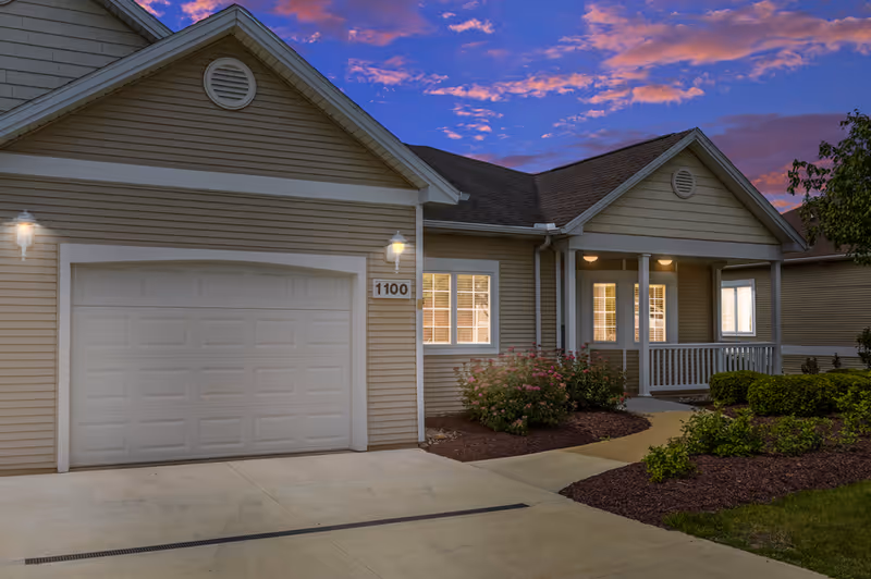 Exterior view of Vista Grande Villa facility with garage and welcoming front porch.