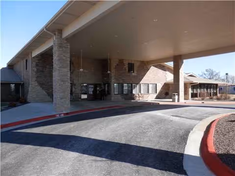 Exterior view of Jordan Creek Nursing & Rehab entrance under a covered drive.