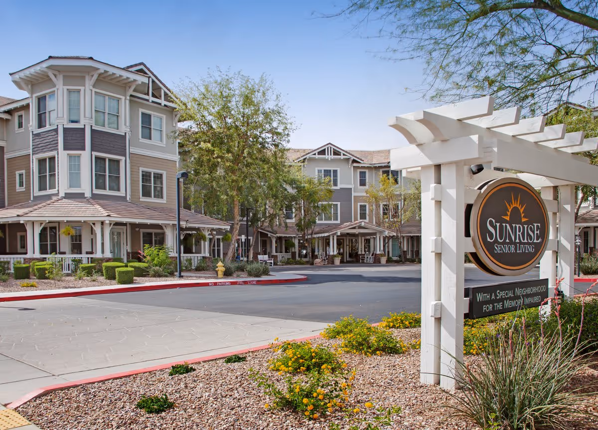 Front exterior of the Sunrise Senior Living building with a landscaped entrance and a prominent sign.