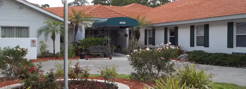 Exterior view of Cabot Reserve on the Green with a green awning entrance.