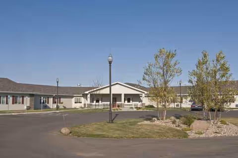 Exterior view of Tea Retirement Living facility with driveway and trees.
