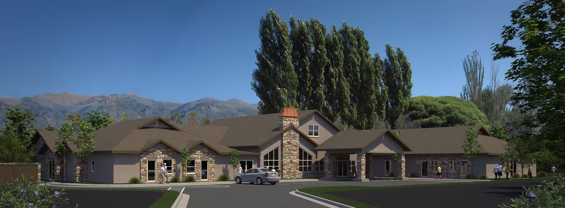 Front exterior of a single-story assisted living building with stone accents, a parked car, and trees with mountains in the background.