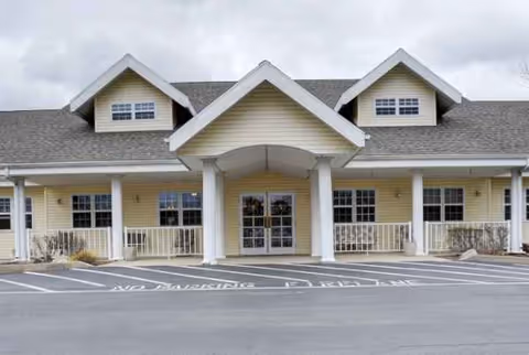 Front view of Chandler Place senior living facility entrance with a covered porte-cochere