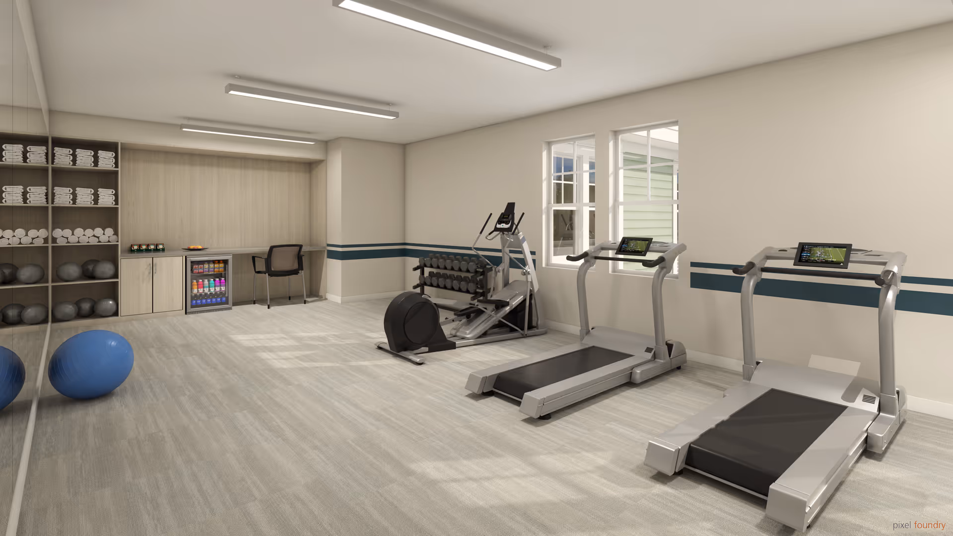 A bright and spacious fitness room with two treadmills, an elliptical machine, a rack of dumbbells, exercise balls, and shelves stocked with towels and water bottles. There is a small refrigerator and a chair against the far wall, and large windows letting in natural light.