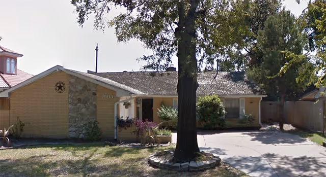 Front view of Tender Care Assisted Living 2 building with driveway and large tree.