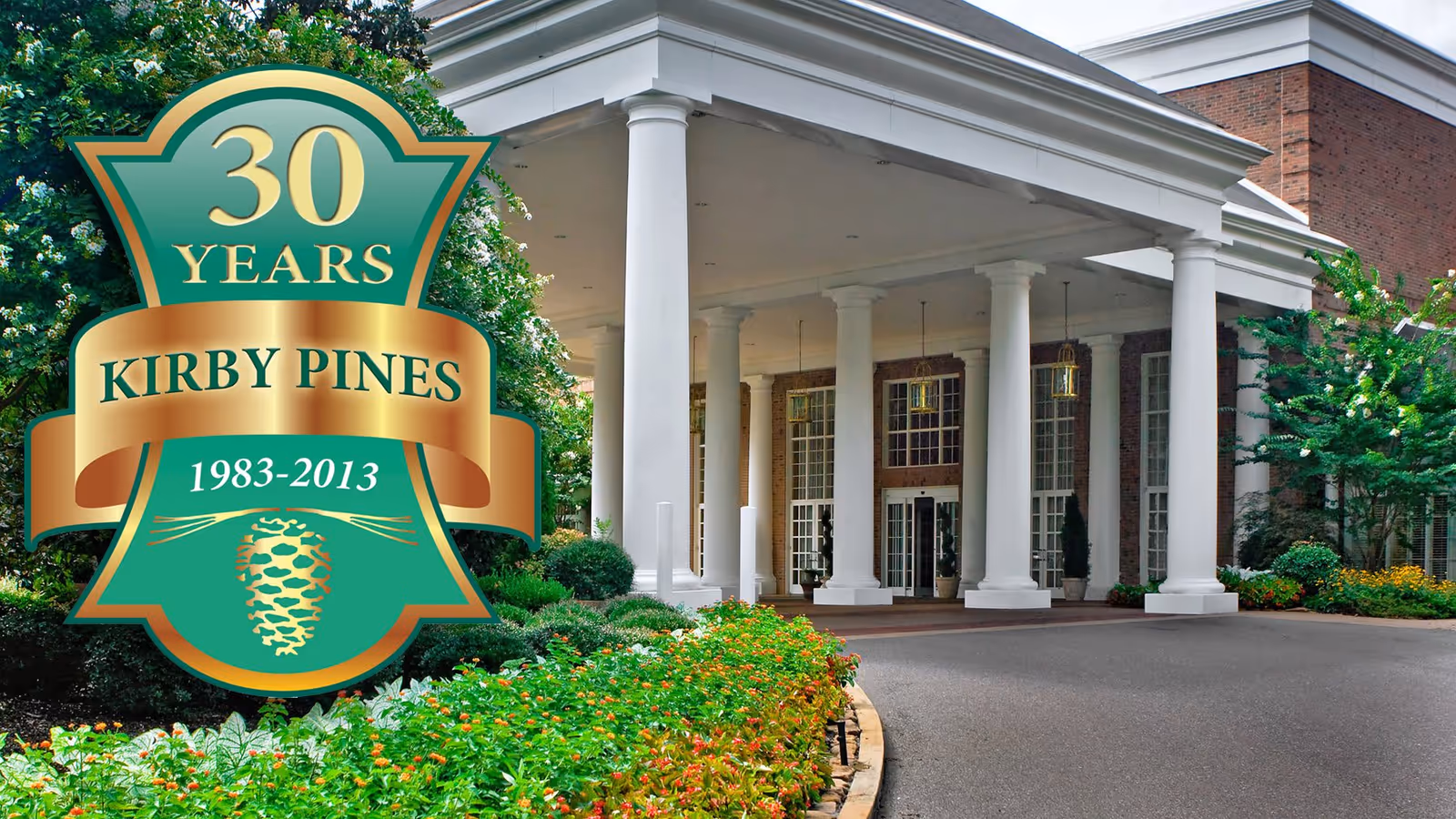 Entrance of Kirby Pines LifeCare Community featuring a covered driveway with large white columns, brick building facade, and landscaped garden with green shrubs and colorful flowers.