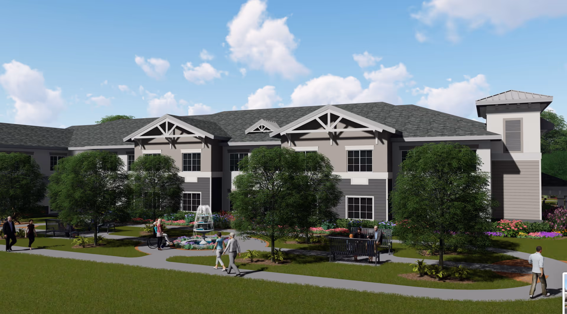 Exterior view of a senior living facility building with a gray roof and beige walls, surrounded by green trees, colorful flower beds, and a walking path. Several people are walking and sitting on benches near a small fountain in the landscaped garden area.
