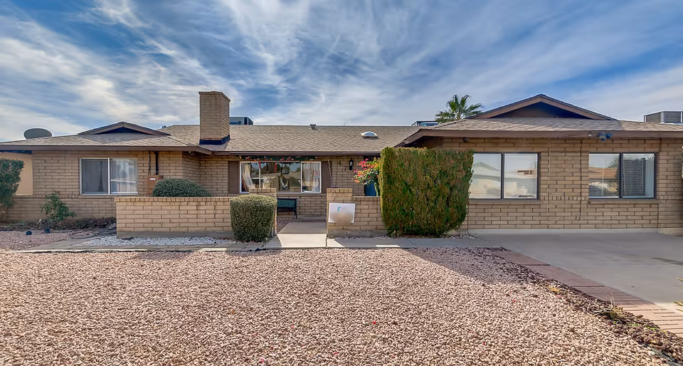 Front view of Desert Haven AZ senior living building with brick exterior and desert landscaping.