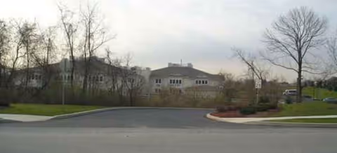 Brookdale Grandon Farms exterior building facade seen from street with trees.