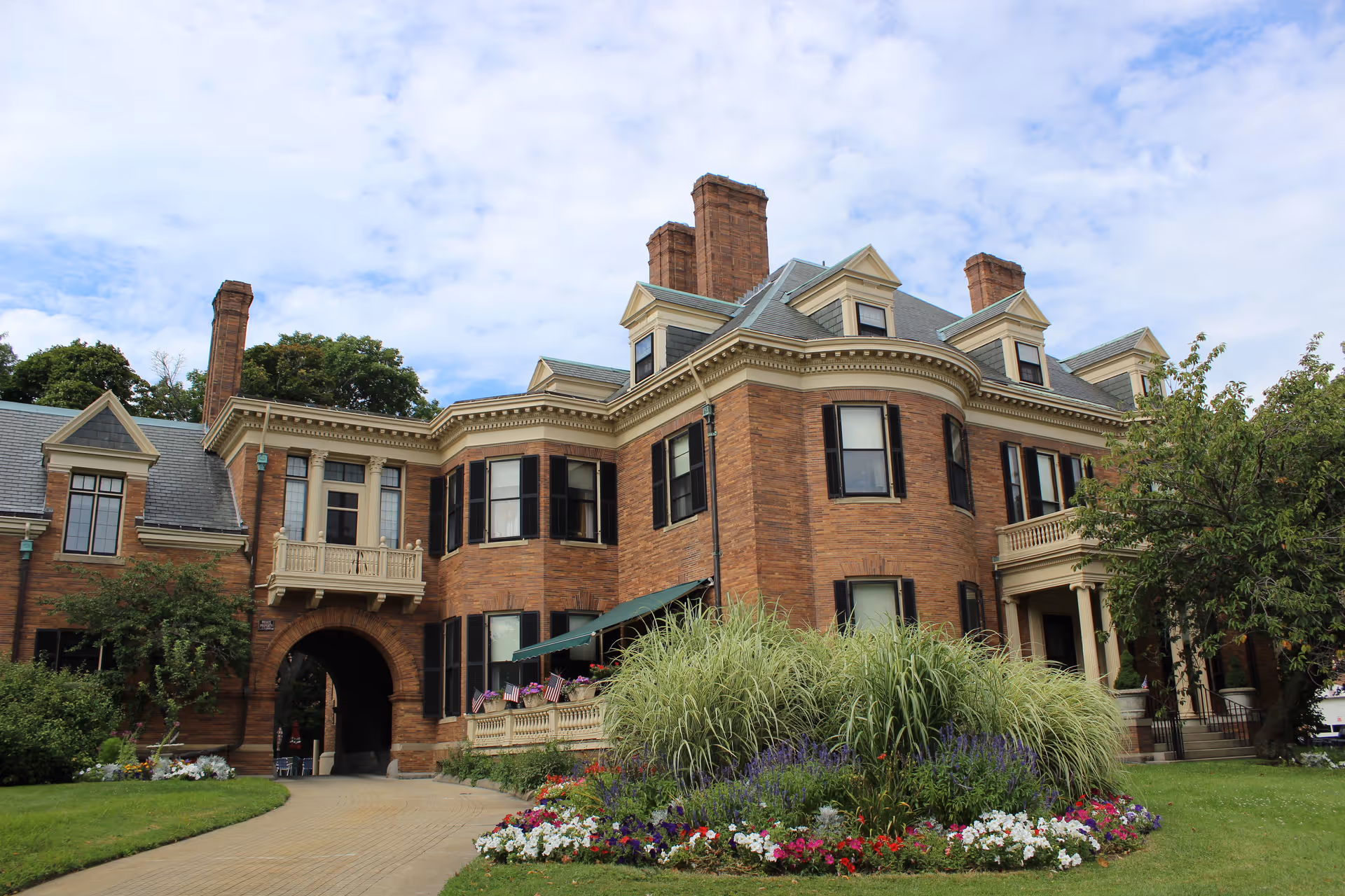 The exterior of Davenport Memorial Home, a large brick building surrounded by landscaped gardens.
