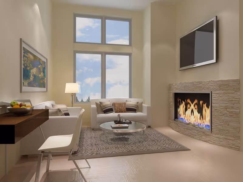 Bright modern living room with sofas, a coffee table, a lit fireplace and a wall-mounted TV beneath tall windows.