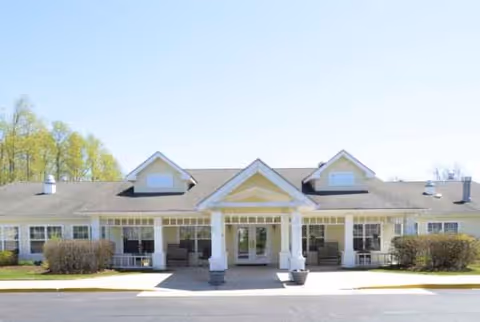 Front view of a single-story senior living facility with a central entrance.