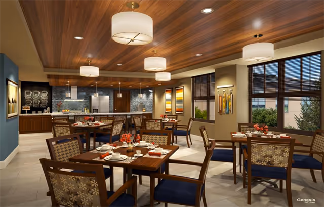 Communal dining room with multiple set wooden tables and chairs, pendant lights, a serving counter, and large windows.