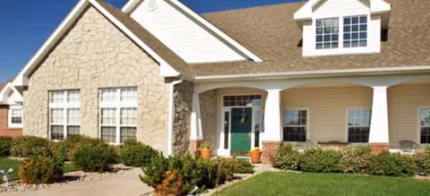 Exterior view of Brookdale Chickasha senior living facility with a green front door.