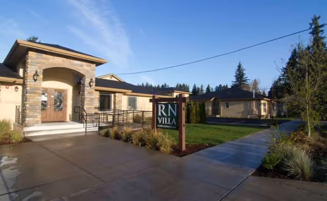 Exterior view of RN Villa Senior Care with entrance, sign, and landscaping.
