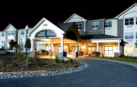 Exterior view of Westchester Manor Nursing Center front entrance with driveway and landscaping.