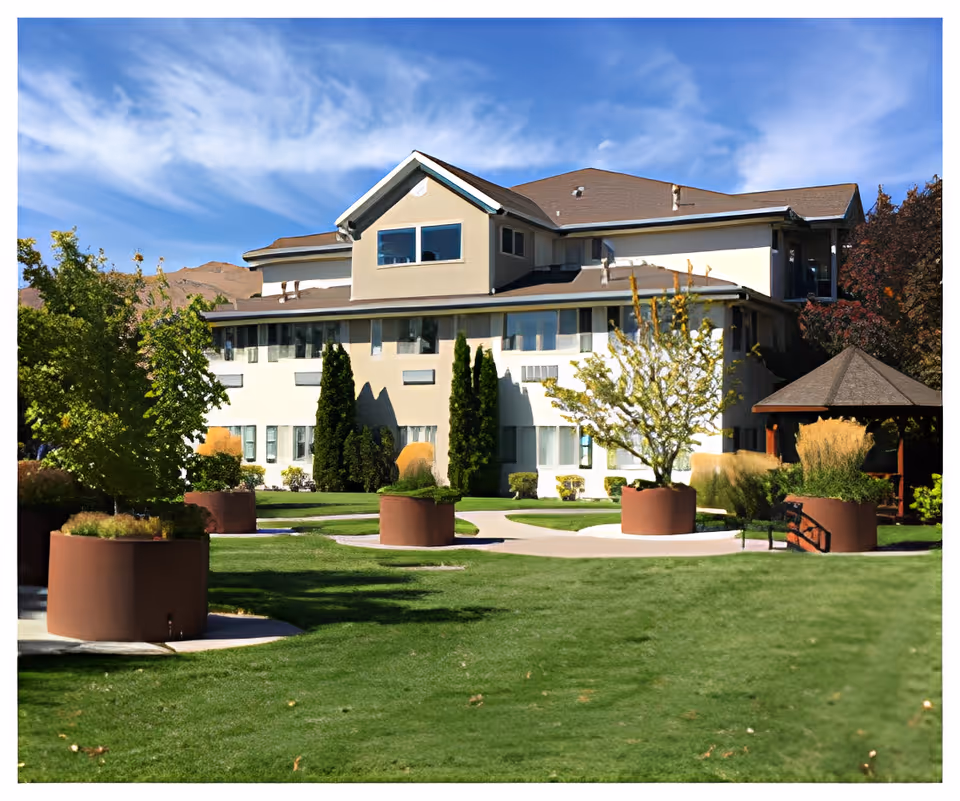 A senior living facility with landscaped grounds and a gazebo.
