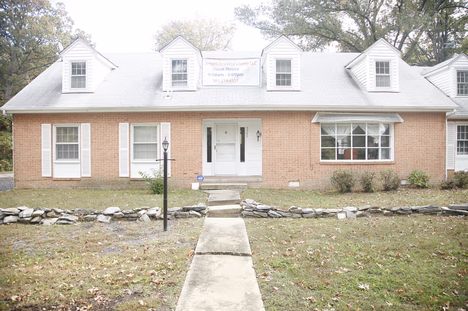 Front view of a brick assisted living facility with a banner sign.