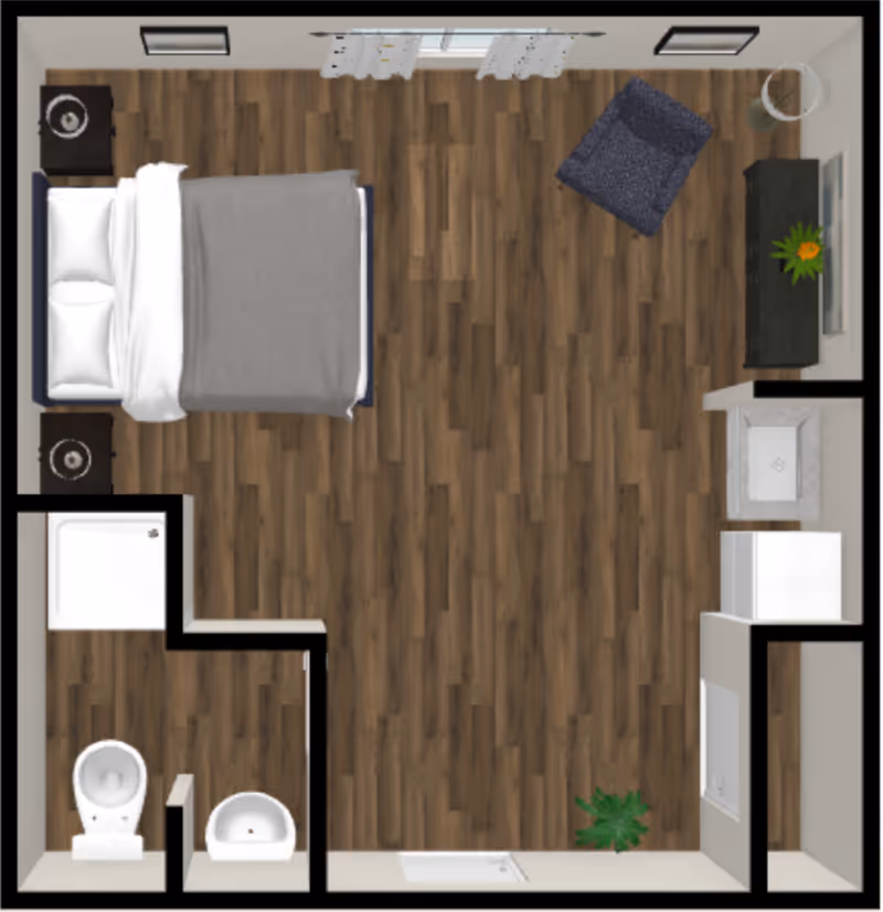 Top-down floor plan of a small assisted living apartment featuring a bedroom area with a bed and two nightstands, a bathroom with a toilet, sink, and shower, and a living area with a chair, a cabinet with a plant, and a small sink area.