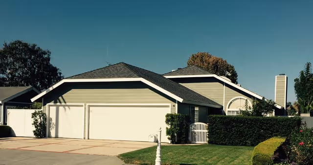Cameo Homes - Eastside I exterior with a driveway, garage, and manicured lawn.