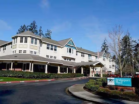 Exterior view of Bridgeport Place Assisted Living building with entrance and sign.