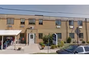 Exterior view of Jersey Shore Skilled Nursing and Rehabilitation Center with entrance and parked cars.