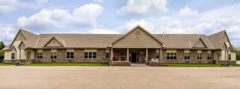 Exterior view of Bay Harbor of Beaver Dam, a single-story senior living facility.
