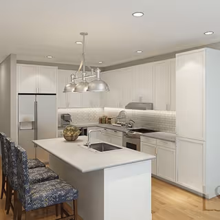 Modern kitchen with white cabinetry, a large island with a built-in sink, three patterned upholstered bar stools, stainless steel refrigerator, stove, and overhead pendant lighting.