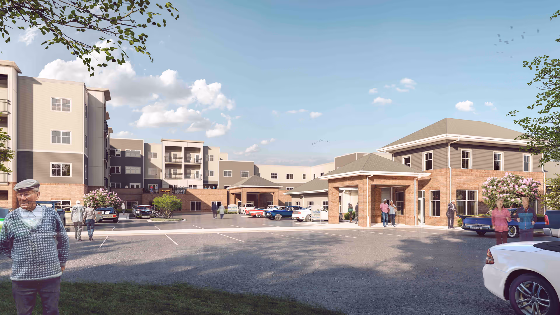 Front exterior of a multi-story senior living facility with a covered entrance, parked cars, and people in the parking lot.