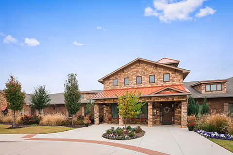 Meadowood senior living facility exterior with brick facade, welcoming entrance, and landscaped surroundings