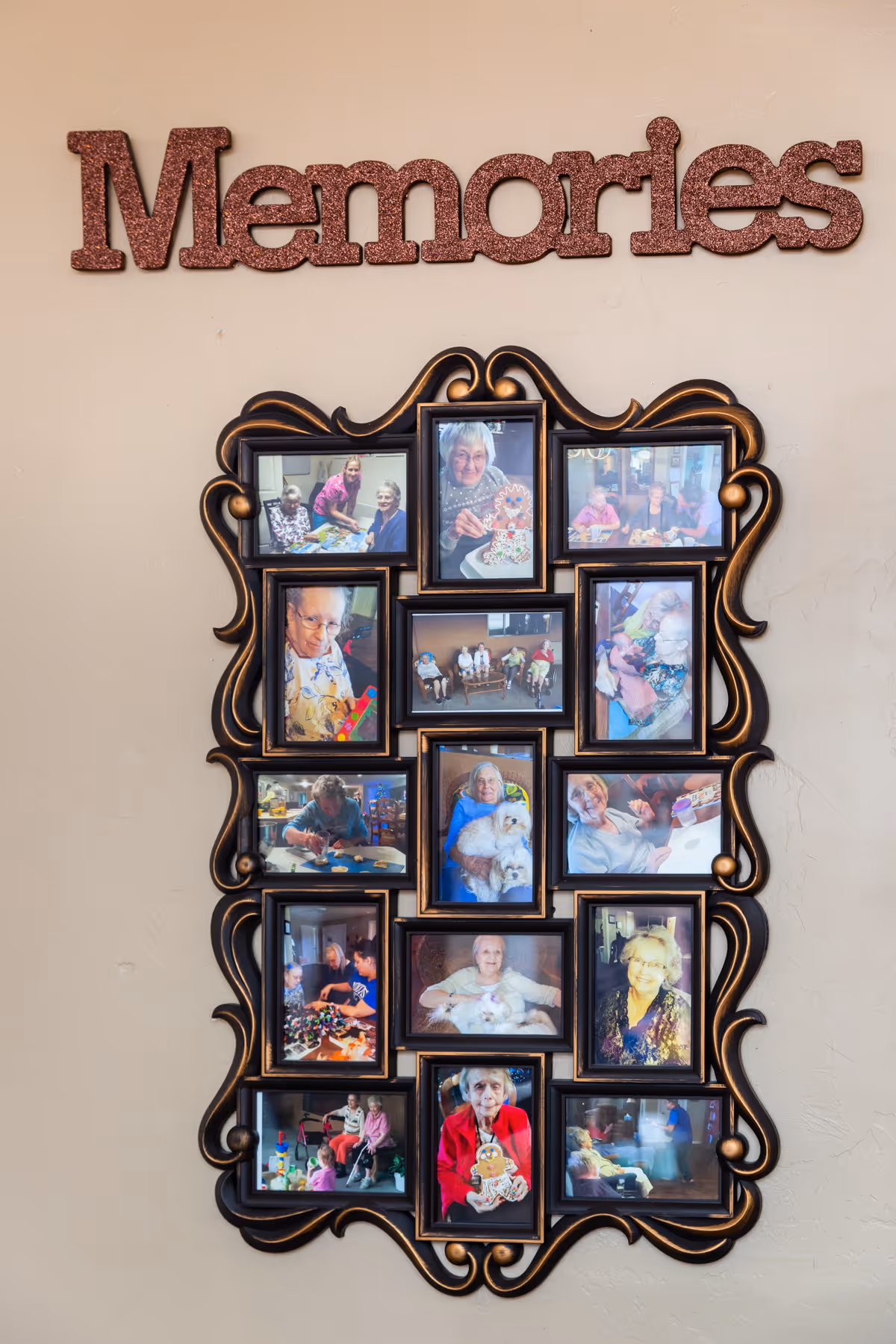 A decorative photo frame with multiple pictures of elderly people engaged in various activities, smiling, and spending time together. Above the frame, the word 'Memories' is displayed in large, glittery letters on a beige wall.