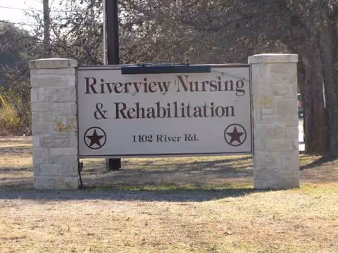 Outdoor stone entrance sign for Riverview Nursing & Rehabilitation with star emblems.