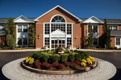 Exterior view of Bear Mountain at Andover facility with brick facade and circular landscaped entrance.
