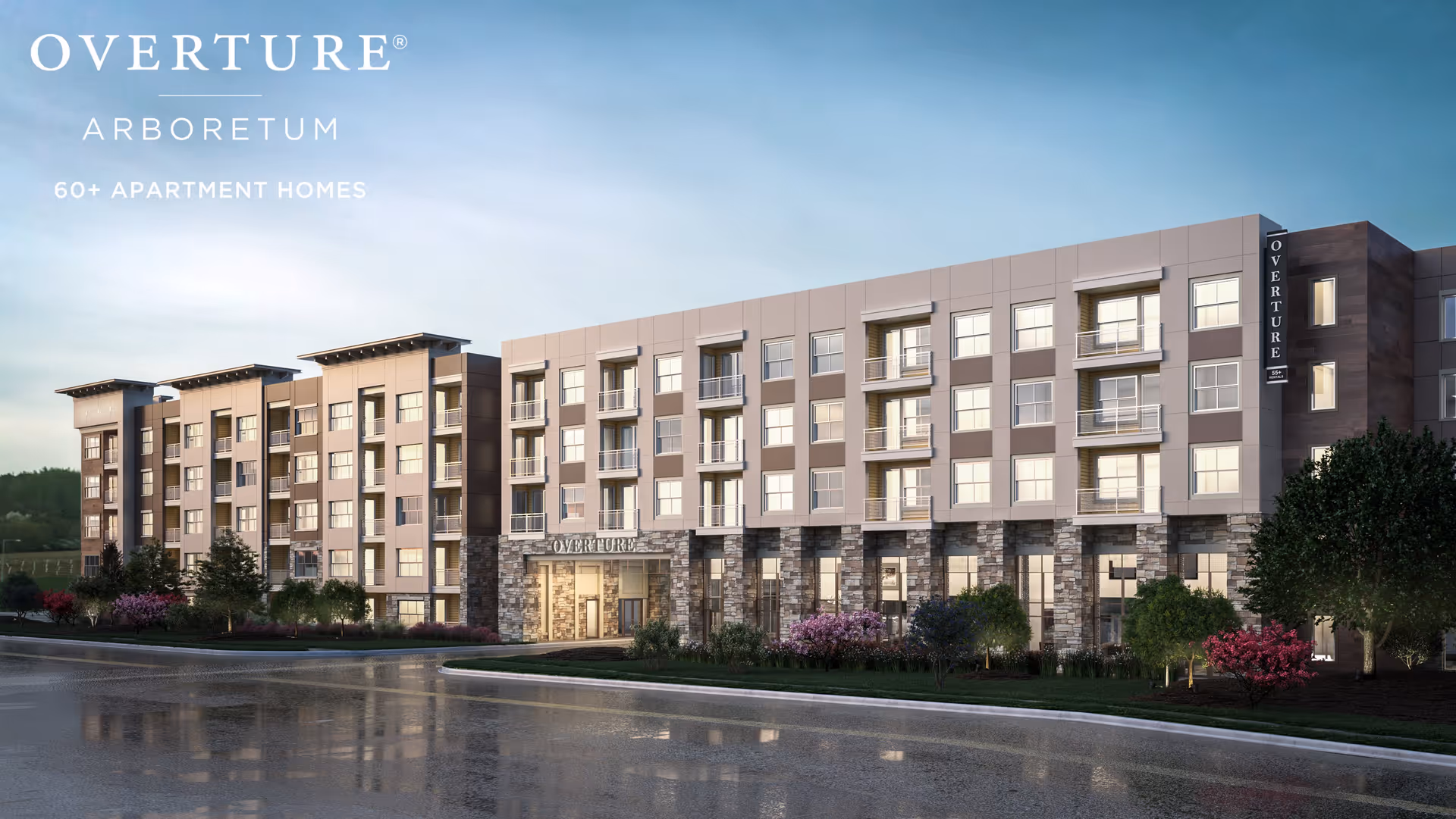 Front exterior of the Overture Arboretum multi-story senior apartment building with landscaped grounds and a wet driveway.