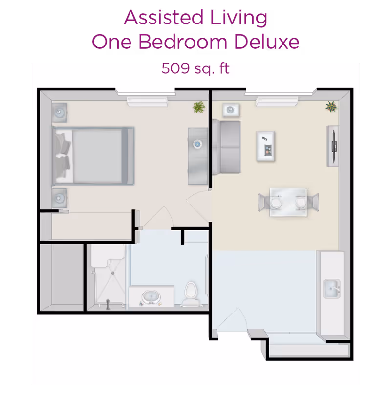 Floor plan of an assisted living one bedroom deluxe apartment with 509 square feet, showing a bedroom with a bed and two nightstands, a living room with a sofa, coffee table, TV, and dining table with two chairs, a kitchen area with a sink, and a bathroom with a shower, sink, and toilet.