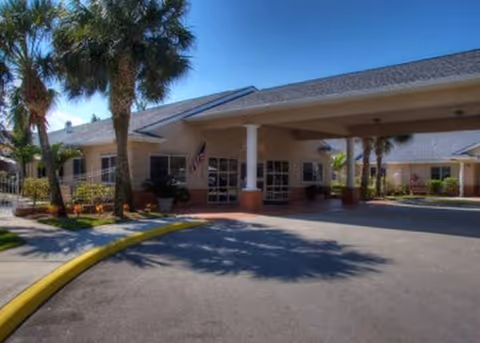 Entrance of Ventura Health and Rehabilitation Center with a covered drop-off area and palm trees.