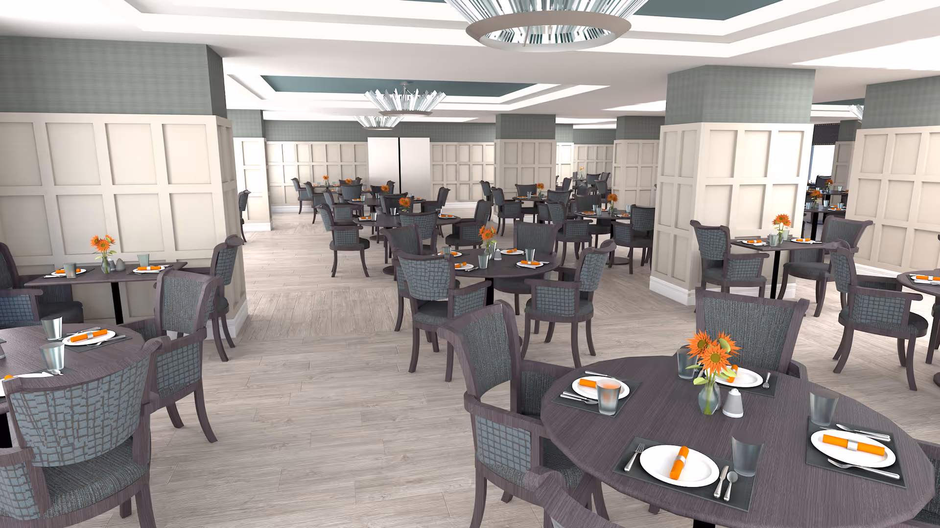 A spacious dining room with multiple round tables set with plates, silverware, glasses, and orange napkins. Each table has a small vase with orange flowers. The room features light wood flooring, paneled walls painted in a soft grayish tone, and modern ceiling light fixtures.