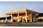Front view of Medicalodges Great Bend facility with brick exterior and covered entrance.