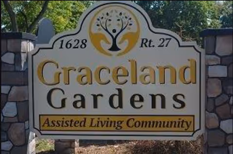 Graceland Gardens sign beside a stone entrance for assisted living.