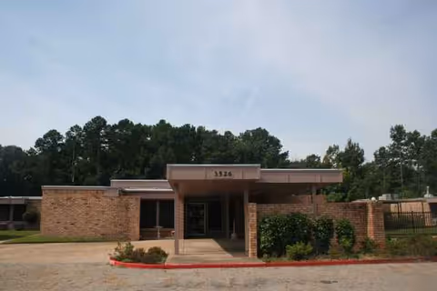 Front view of Greenbrier Nursing and Rehabilitation Center of Tyler entrance with brick facade.