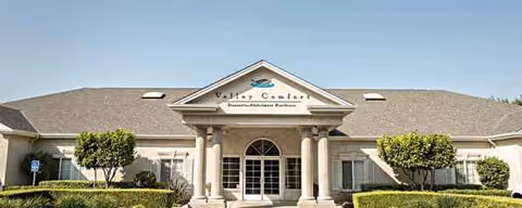 Front exterior of Valley Comfort senior living facility with columns.