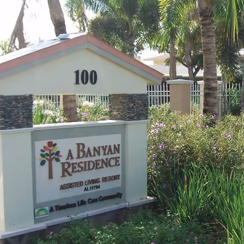 Entrance sign for A Banyan Residence with landscaping and the number 100.